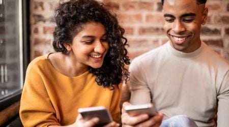 Friends paying overseas bills via mobile app