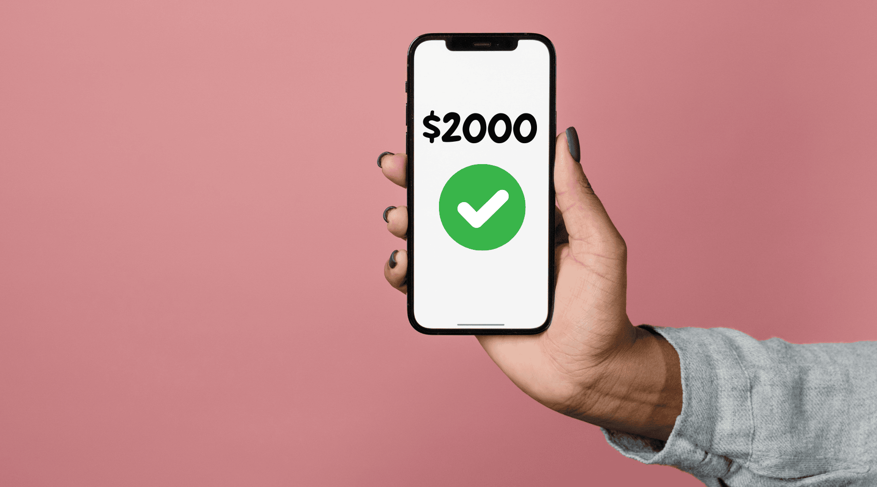 Hand holding phone with $2000 on screen