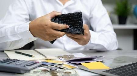 Looking money in wallet